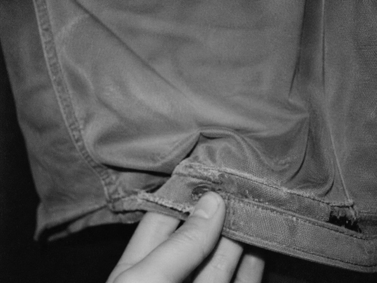 Close detail of heavy cotton garment seam and drawstring