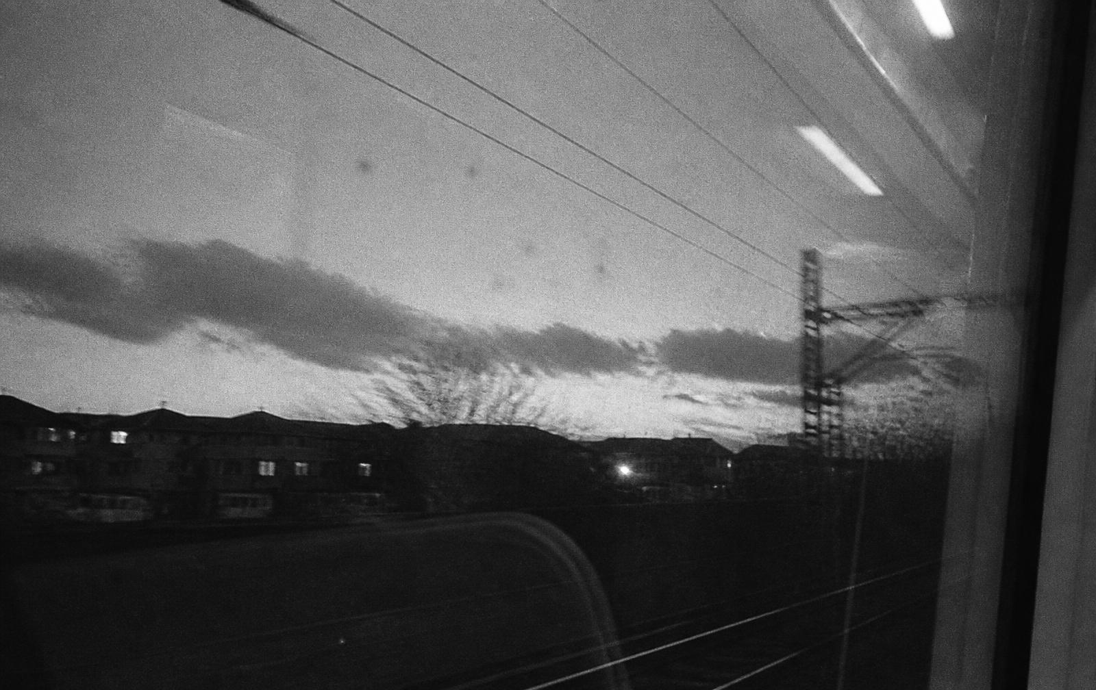 Empty night platform with a distant anonymous silhouette